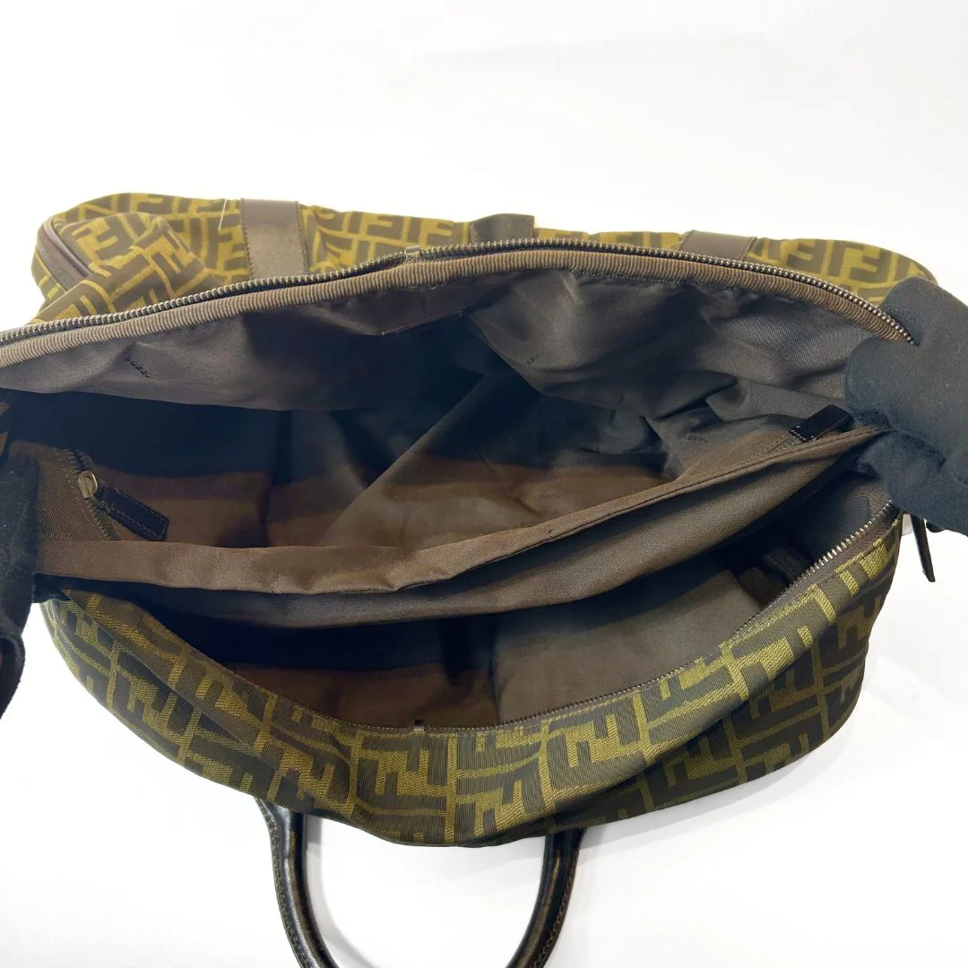 Open backpack with green and brown pattern on a white background