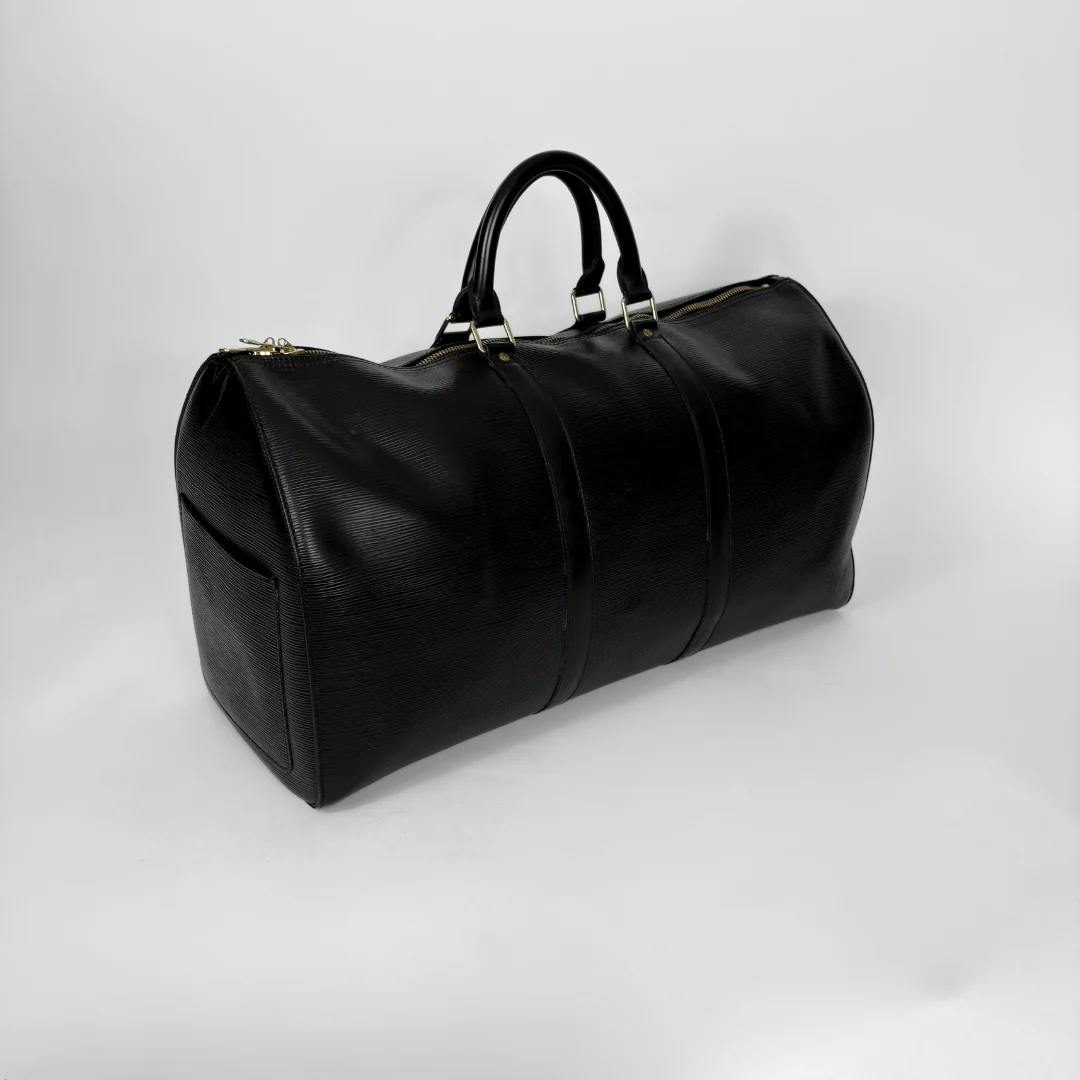 Black leather duffel bag on a light gray background