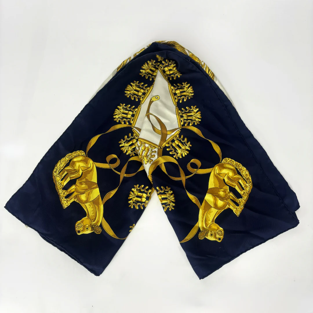 Navy blue fabric with gold embroidery featuring a central emblem and two lion-like figures on a white background